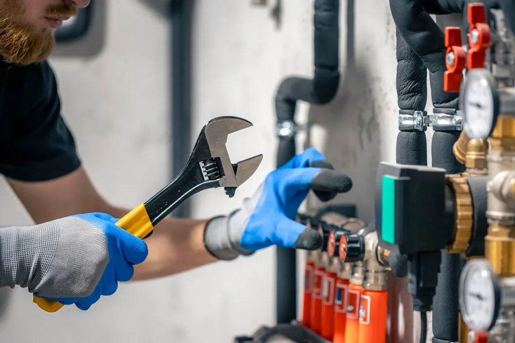 Maintenance worker fixing pipes